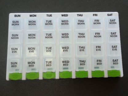 white and green pill organizer