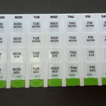white and green pill organizer