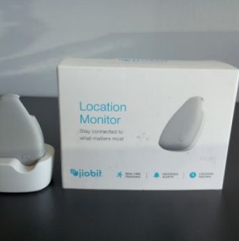 White box with photo of tracker on it